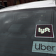 Windshield displaying Lyft and Uber decals